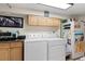 Laundry room includes a washer, dryer, cabinets, and refrigerator at 16 N Pennsylvania St, Denver, CO 80203