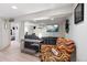 Cozy living room with bright recessed lights, TV, grey couch, and colorful armchair at 16 N Pennsylvania St, Denver, CO 80203