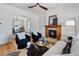 Bright living room featuring a fireplace, hardwood floors, ceiling fan, and stylish furniture at 16 N Pennsylvania St, Denver, CO 80203