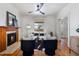 Cozy living room with a fireplace, hardwood floors, ceiling fan, and comfortable seating at 16 N Pennsylvania St, Denver, CO 80203
