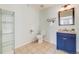 Bright bathroom featuring blue vanity, granite countertops, and an open layout at 22765 E Ottawa Pl, Aurora, CO 80016