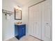 Cozy bathroom with blue vanity, granite countertops, and plenty of storage space in the three door closet at 22765 E Ottawa Pl, Aurora, CO 80016