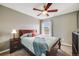 Cozy bedroom with a ceiling fan, warm colors, and natural light from the window creates a relaxing atmosphere at 22765 E Ottawa Pl, Aurora, CO 80016
