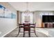 Modern dining area featuring a wooden table with seating for four and stylish lighting fixtures at 22765 E Ottawa Pl, Aurora, CO 80016