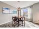 Cozy dining room featuring a wooden table with seating for four and a modern chandelier at 22765 E Ottawa Pl, Aurora, CO 80016