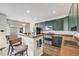 Modern kitchen with dark cabinets, granite counters, stainless appliances, and bar stools at 22765 E Ottawa Pl, Aurora, CO 80016