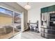 Open concept kitchen with stainless fridge and view of outdoor patio seating at 22765 E Ottawa Pl, Aurora, CO 80016