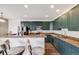Kitchen with dark cabinets, granite counters, stainless appliances, and bar seating at 22765 E Ottawa Pl, Aurora, CO 80016