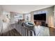 Bright and spacious living room with modern furniture, an adjacent dining area, and hardwood floors at 22765 E Ottawa Pl, Aurora, CO 80016