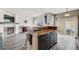 Spacious living room with barstool seating, modern fireplace and access to deck at 22765 E Ottawa Pl, Aurora, CO 80016