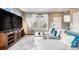 Bright living room featuring a large-screen TV, stylish furniture, and natural light from big windows at 22765 E Ottawa Pl, Aurora, CO 80016