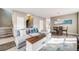 Open-concept living room with hardwood floors, modern decor, and a comfortable sectional sofa at 22765 E Ottawa Pl, Aurora, CO 80016