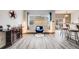Living room with wood floors, bar and barstool seating, with bright window at 22765 E Ottawa Pl, Aurora, CO 80016