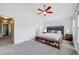Bright main bedroom featuring a ceiling fan and ample natural light from three large windows, offering a peaceful retreat at 22765 E Ottawa Pl, Aurora, CO 80016