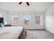 Sunlit main bedroom offering three windows with neighborhood views and a ceiling fan for comfort and style at 22765 E Ottawa Pl, Aurora, CO 80016