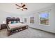 Spacious main bedroom filled with natural light from three large windows, complete with ceiling fan and a shoe bench at 22765 E Ottawa Pl, Aurora, CO 80016