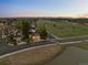A picturesque view of the home and neighborhood near open fields and mountain views at 6402 W 81St Ave, Arvada, CO 80003