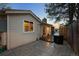 Backyard with a stone patio, wooden deck, well-maintained siding, and view of the sky at dusk at 6402 W 81St Ave, Arvada, CO 80003