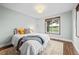 Bright bedroom with hardwood floors, windows with neighborhood view, a comfortable bed and neutral décor at 6402 W 81St Ave, Arvada, CO 80003