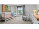 Charming Bedroom featuring a crib, artwork, a comfortable chair and a bright window at 6402 W 81St Ave, Arvada, CO 80003