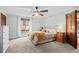 Bedroom featuring a ceiling fan, natural light, and neutral color palette at 6402 W 81St Ave, Arvada, CO 80003