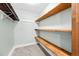 Walk-in closet with custom wood shelving for optimal storage at 6402 W 81St Ave, Arvada, CO 80003
