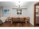 Dining room features modern light fixture, hardwood floors and ski resort wall art at 6402 W 81St Ave, Arvada, CO 80003