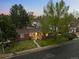 Charming brick home nestled among mature trees boasts classic curb appeal at 6402 W 81St Ave, Arvada, CO 80003