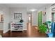 Bright hallway with hardwood floors, a unique green door, and stylish decor at 6402 W 81St Ave, Arvada, CO 80003