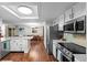 Open concept kitchen with stainless appliances, eat-in island and hardwood floors at 6402 W 81St Ave, Arvada, CO 80003