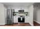 Kitchen boasts stainless steel appliances, sleek countertops, and modern tile backsplash at 6402 W 81St Ave, Arvada, CO 80003