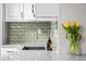 Close-up of modern kitchen sink with stainless faucet and light grey countertops at 6402 W 81St Ave, Arvada, CO 80003