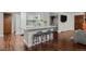 Modern kitchen with white cabinets, a breakfast bar, and an open layout at 6402 W 81St Ave, Arvada, CO 80003