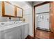 Functional laundry area leading to a modern bathroom with a glass enclosed shower at 6402 W 81St Ave, Arvada, CO 80003