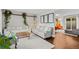Comfortable living room with neutral furnishings, hardwood floors, and a slider to the deck at 6402 W 81St Ave, Arvada, CO 80003