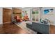 Living room with a brick fireplace, hardwood floors, and a slider to the deck at 6402 W 81St Ave, Arvada, CO 80003