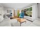 Cozy living room with hardwood floors, a green front door, and a large window at 6402 W 81St Ave, Arvada, CO 80003