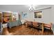 Open concept living space features a dining table and living area with fireplace at 6402 W 81St Ave, Arvada, CO 80003