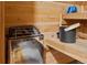 Close up of the sauna heater, wooden benches, bucket and hats at 6402 W 81St Ave, Arvada, CO 80003