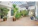 Bright atrium with a glass roof, spiral staircase, and lush greenery throughout the home at 1732 Wazee St # 201, Denver, CO 80202