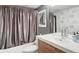 Modern bathroom featuring sleek vanity, a large mirror, and a shower with a privacy curtain at 1732 Wazee St # 201, Denver, CO 80202