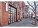 Charming brick building featuring Robischon Gallery with large windows and sidewalk planters at 1732 Wazee St # 201, Denver, CO 80202