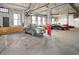 Spacious indoor parking with natural lighting, exposed beams, and multiple vehicles parked at 1732 Wazee St # 201, Denver, CO 80202