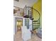 Modern interior with hardwood floors, spiral staircase, and view into another room at 1732 Wazee St # 201, Denver, CO 80202