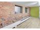 Exposed brick wall with windows and wood floors adds charm to this modern industrial space at 1732 Wazee St # 201, Denver, CO 80202