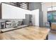 Bright kitchen with stainless appliances, white cabinets, custom backsplash, and wood breakfast table at 1732 Wazee St # 201, Denver, CO 80202