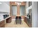 Stylish kitchen with stainless steel appliances, a long dining table, and modern fixtures at 1732 Wazee St # 201, Denver, CO 80202