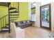 Bright living area features a spiral staircase, modern furniture, light wood floors, and natural light at 1732 Wazee St # 201, Denver, CO 80202