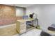 Charming office space with exposed brick wall, light wood desk, and modern decor at 1732 Wazee St # 201, Denver, CO 80202
