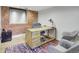 Cozy office space features exposed brick, a stylish desk, and a colorful rug, creating a vibrant atmosphere at 1732 Wazee St # 201, Denver, CO 80202